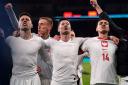 Jan Bednarek celebrates with his Poland teammates after they reach Euro 2024