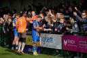 Basingstoke Town players celebrate with fans after their win against Dorchester Town