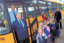 Yellow bus driver Mike Keer and standby driver Shaun Sadler with Kempshott Infant School pupils and the school's deputy head Matthew Lowden