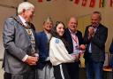 From left to right: Mayor Paul Miller, BMF chair Shibaji Shrestha, Labour councillor Andy McCormick  and Basingstoke and Deane Borough Council leader Simon Minas -Bound present an award to a student at the Language Day Celebration