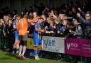 Basingstoke Town players celebrate with fans after their win against Dorchester Town