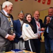 From left to right: Mayor Paul Miller, BMF chair Shibaji Shrestha, Labour councillor Andy McCormick  and Basingstoke and Deane Borough Council leader Simon Minas -Bound present an award to a student at the Language Day Celebration