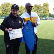 Dan Brownlie being presented with the award by Rotary president Tunde Adelakun