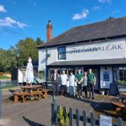 Alex Gooch (left) with his staff in front of The Royal Oak in Ecchinswell near Newbury.