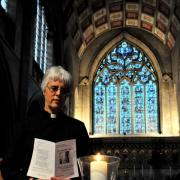The Reverend Rosalind Rutherford lights a candle at All Saints' Church, in Basingstoke