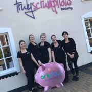 Staff at Truly Scrumptious with Moneypenny, the Ark Day mascot. Image; Rod Clarke