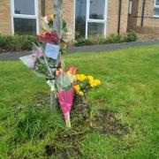 Tributes left at Braddock Court after man in 40s was stabbed to death