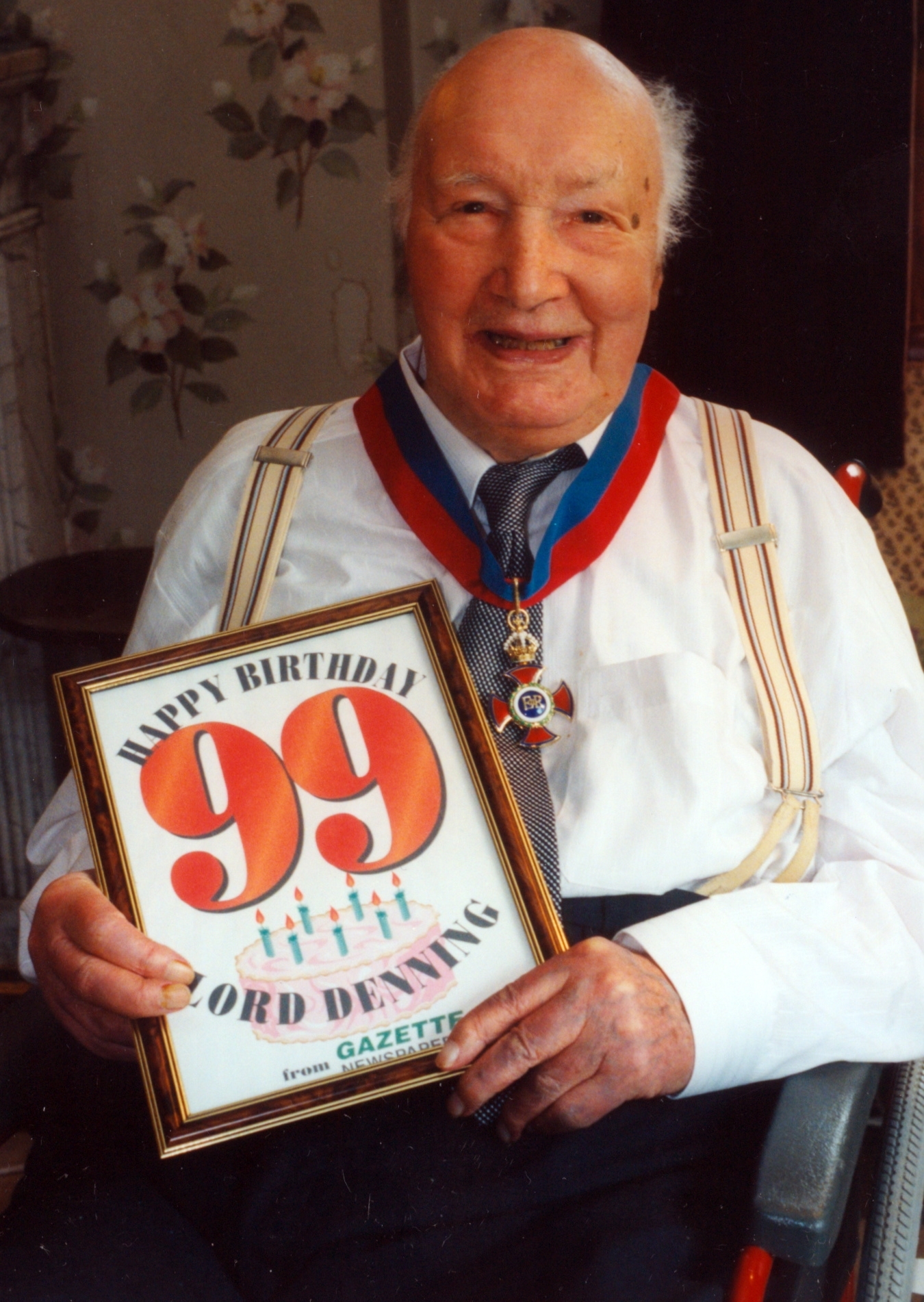 Lord Denning with a birthday card on his 99th birthday