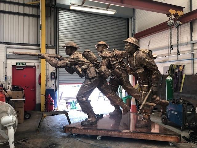 The sculptures of three charging infantrymen, which weigh over a ton each, were made in Basingstoke.