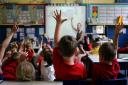 File photo dated 06/07/11 of children at school in Stockport raising their hands to answer a question as teachers should attempt to stop boys from dominating lessons, a union leader has suggested. PRESS ASSOCIATION Photo. Issue date: Friday September 13, 
