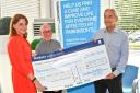 Emma Simms, left, presents a cheque of £375 to Parkinson's UK Basingstoke branch