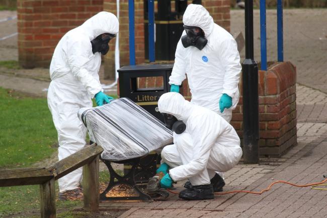 Investigators in protective suits removed the bench where Sergei and Yulia Skripal were found poisoned in Salisbury. Picture by Spencer Mullholland