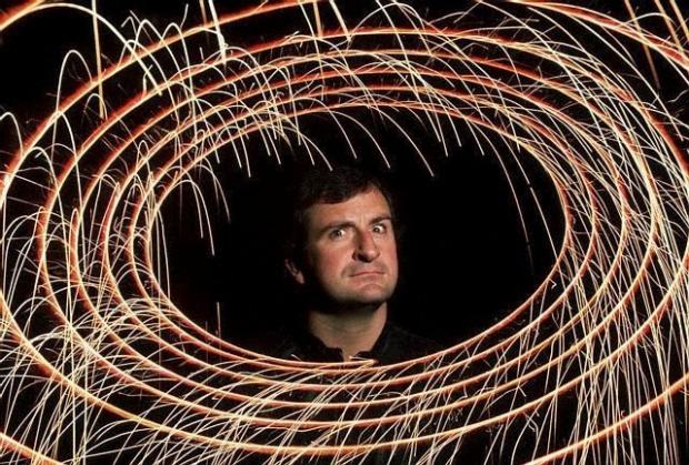 Basingstoke Gazette: Douglas Adams, author of The Hitchhiker's Guide to the Galaxy shoots an "evil genius" look through a series of spacelike elliptical rings.