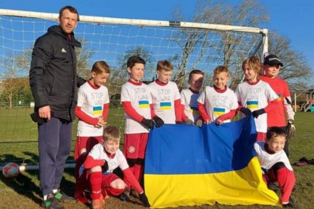 Sherborne St John FC U9s Saints team wearing t-shirts with Ukraine's flag