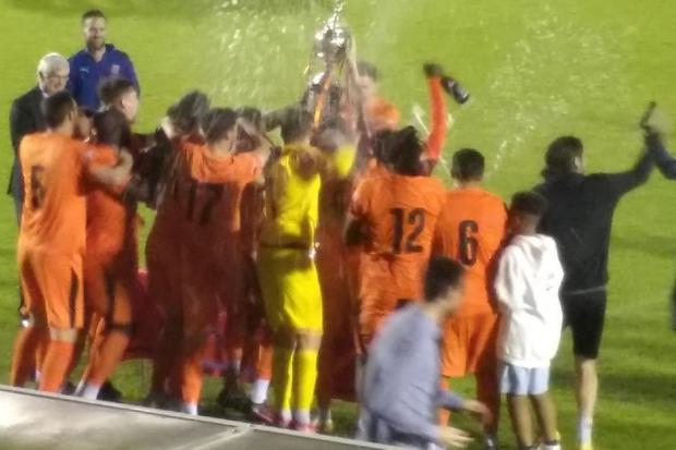 Hartley Wintney players celebrate with the trophy