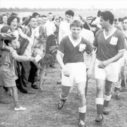 Tommy Steele and Bernie Winters leave the Camrosefootball ground after a charity match