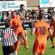 Hartley Wintney and Bath City players fight for the ball. Credit: Josie Shipman