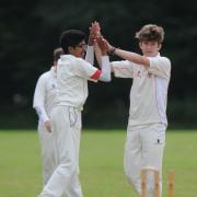 Odiham's Arthur Rowe-Jones (right) clebrates a wicket against St Mary's