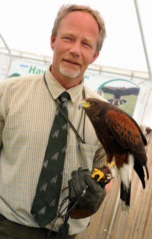 David Hughes, from Hawkwalk, holding up Squeek the Harris hawk which was on display